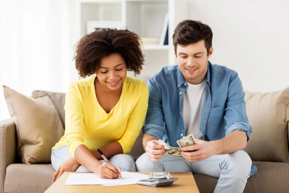 Man and woman on couch happy that they are saving money on move related services through ReloZip