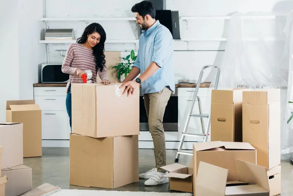 Man and woman moving boxes into their new home using a ReloZip agent