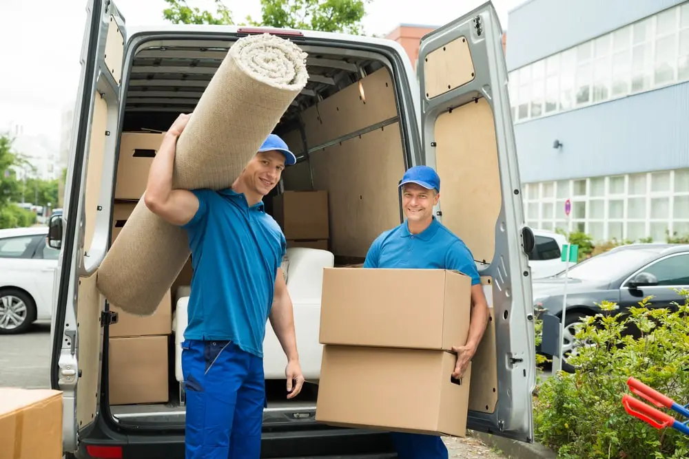 2 moving men unloading truck in front of house